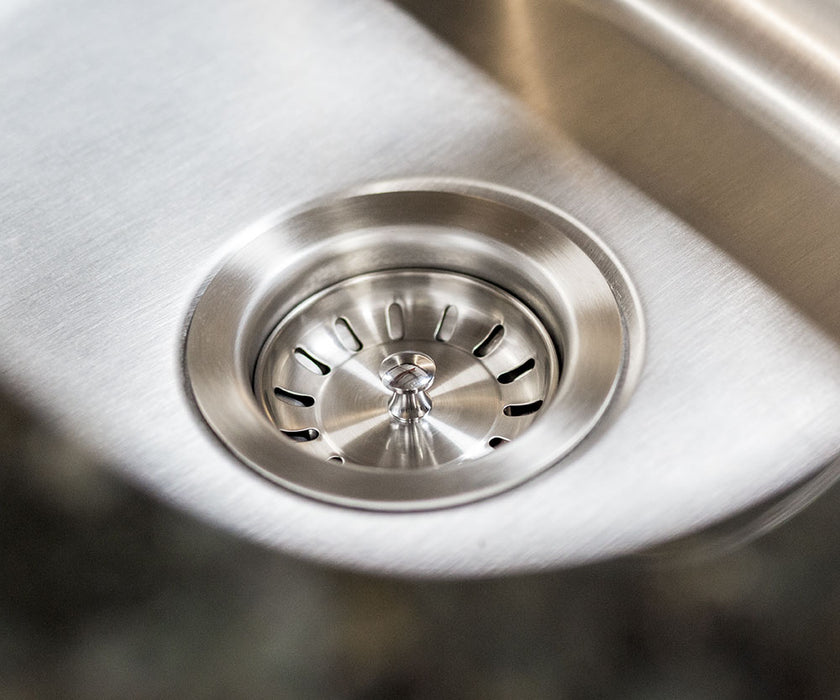 Stono Outdoor Living Close-up of the TrueFlame 19" x 15" Stainless Steel Undermount Sink (TF-NK-19U), featuring a clean drain with metal strainer and smooth, shiny finish—perfect for any modern indoor or outdoor kitchen setup.