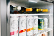 Stono Outdoor Living Cans of White Claw, craft beer, and white wine bottles are neatly arranged inside the TrueFlame 24" Deluxe Outdoor Refrigerator (TF-RFR-24D-R) with a sleek stainless steel door.