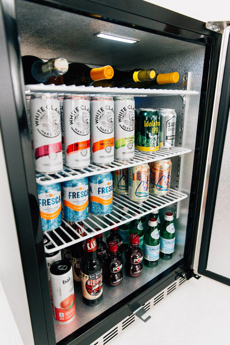 Stono Outdoor Living The TrueFlame 24" Outdoor Rated Refrigerator (5.1 cu. ft.) by TrueFlame is stocked with White Claw, Fresca, La Croix, beer, sparkling water, soda, and wine bottles—perfect to keep drinks cold for your next gathering.