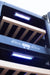 Stono Outdoor Living Close-up of the TrueFlame 15" 3.2 Cu. Ft. Outdoor Rated Single Zone Wine Cooler (AMD-RFR-15W) with wooden shelves and blue LED lighting—perfect to pair with stainless steel appliances in modern outdoor kitchens.