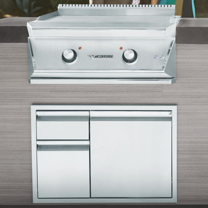 Stono Outdoor Living The Twin Eagles 30-Inch Built-In Propane Gas Teppanyaki Griddle (TETG30-CL) features two control knobs and a closed stainless steel storage cabinet, seamlessly built into a modern outdoor kitchen with a sleek cooking surface.