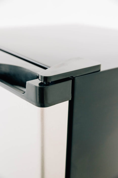 Stono Outdoor Living Close-up of the top corner of the TrueFlame 22" 4.1c Outdoor Approved Fridge (AMD-RFR-22S), showing its stainless steel reversible door with lock and black handle against a white background.