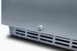 Stono Outdoor Living Close-up of the TrueFlame 15" 3.2 Cu. Ft. Outdoor Rated Refrigerator (AMD-RFR-15S) metallic surface, showing a lock mechanism and vented grille, highlighting its durable stainless steel design for outdoor use.