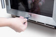 Stono Outdoor Living A hand inserts a key into the lock of the TrueFlame 15" Outdoor Rated Dual Zone Wine Cooler (AMD-RFR-15WD), a sleek stainless steel appliance with a glass door showing bottles inside.