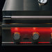 Stono Outdoor Living Close-up of the TrueFlame 32" 4-Burner Built-In Natural Gas Grill (TF32), highlighting its illuminated red control panel, four knobs, built-in lid thermometer, and premium stainless steel finish with the TrueFlame logo.