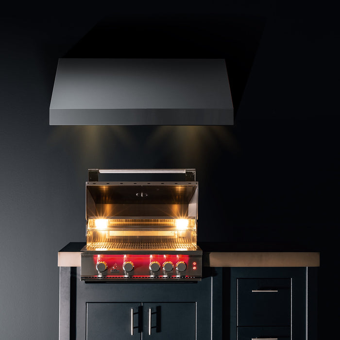 Stono Outdoor Living The TrueFlame 40" 5-Burner Built-In Propane Gas Grill (TF40L) by TrueFlame features a red control panel with five knobs, is set in dark cabinetry under a black range hood, and has its stainless steel lid open with interior lights on.