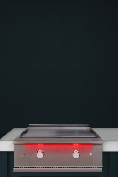 Stono Outdoor Living The TrueFlame 30" Built-In Propane Gas Grill Griddle (TFG30L) features two red-lit knobs and a sleek stainless steel finish, making it a stylish addition to any outdoor kitchen when set on a white countertop against a dark backdrop.