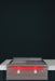 Stono Outdoor Living The TrueFlame 30" Built-In Propane Gas Grill Griddle (TFG30L) features two red-lit knobs and a sleek stainless steel finish, making it a stylish addition to any outdoor kitchen when set on a white countertop against a dark backdrop.
