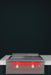 Stono Outdoor Living The TrueFlame 30" Built-In Natural Gas Grill Griddle (TFG30) by TrueFlame, featuring two illuminated red knobs, sits on a white countertop against a dark backdrop, bringing style and sophistication to any outdoor kitchen setup.
