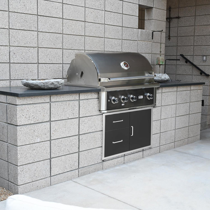 Stono Outdoor Living A Wildfire Ranch Pro 36-in 3 Burner Black 304 SS Natural Gas Grill (WFPRO36G-BSS-NG) by Wildfire Outdoor Living is installed in a grey concrete block counter with storage drawers on a modern patio with light stone flooring.