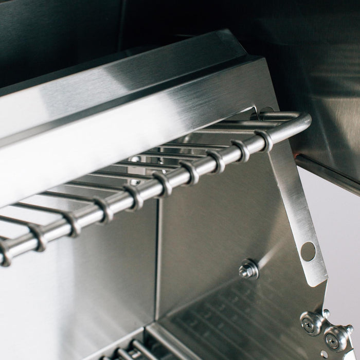 Stono Outdoor Living Close-up of the American Made Grills Estate 30-Inch Grill (EST30-NG) by American Made Grills, featuring a warming rack, metal grates, and sleek stainless steel surfaces with modern construction.