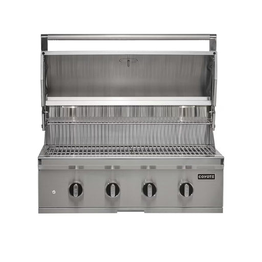 Stono Outdoor Living The Coyote 36" CL-Series Grill, 4 Burner in Propane (C3CL36LP) features 304 stainless steel, four control knobs, open hood, cooking grate, and raised warming rack—perfect for outdoor cooking. The Coyote logo is displayed on the front.