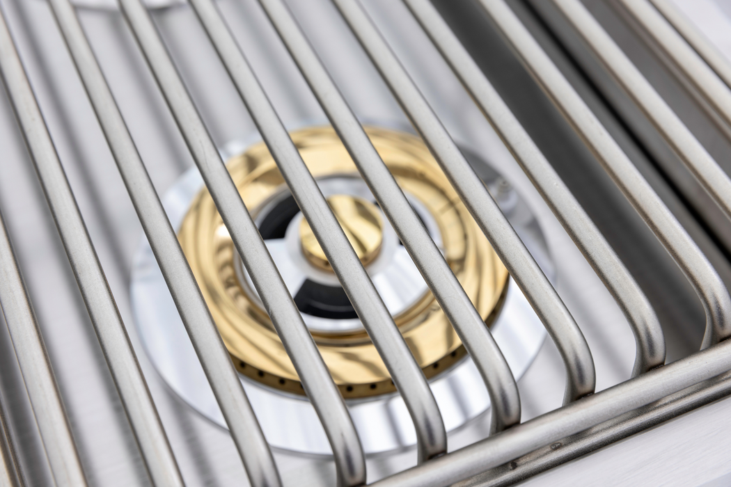 Stono Outdoor Living Close-up of the Blaze Premium LTE+ Natural Gas Stainless Steel Double Side Burner with lid (BLZ-SB2-LTE3-NG), featuring sturdy grates and a gold and black ring—ideal for any outdoor kitchen.