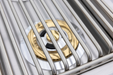 Stono Outdoor Living Close-up of the Blaze Premium LTE+ Natural Gas Stainless Steel Double Side Burner with lid (BLZ-SB2-LTE3-NG), featuring sturdy grates and a gold and black ring—ideal for any outdoor kitchen.