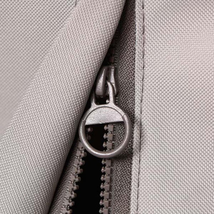 Stono Outdoor Living Close-up of a gray fabric zipper with round metal pull on the Coyote Cover for 36" Grill (CCVR36-BIG). This weather-resistant, textured cover by Coyote is ideal for protecting your outdoor grill.