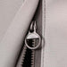 Stono Outdoor Living Close-up of a gray fabric zipper with round metal pull on the Coyote Cover for 36" Grill (CCVR36-BIG). This weather-resistant, textured cover by Coyote is ideal for protecting your outdoor grill.