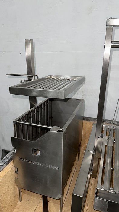 Stono Outdoor Living The Tagwood BBQ Height Adjustable Secondary Grate for BBQ09SS Grill (BBQ96SS) by Tagwood BBQ adds versatility to your grill, providing an adaptable cooking surface ideal for open flame or coal grilling against a light gray wall.