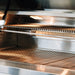 Stono Outdoor Living Close-up of the American Made Grills Estate 30-Inch Natural Gas Grill (EST30-NG) featuring two stainless steel racks and an overhead light, highlighting its clean, modern design ideal for built-in outdoor kitchens.