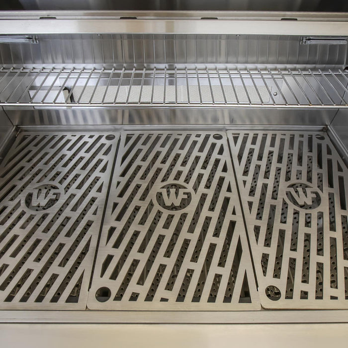 Stono Outdoor Living A close-up of the Wildfire Ranch Pro 36" Gas Grill by Wildfire Outdoor Living shows three embossed grates with diagonal slits, cast stainless steel burners, and a raised warming rack on the sleek black stainless steel grill.