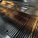 Stono Outdoor Living Close-up of the clean, empty stainless steel grate, warming rack, and drip tray on the TrueFlame 25" 3-Burner Built-In Propane Gas Grill (TF25L), highlighting the durability and quality of this premium TrueFlame grill.