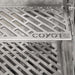 Stono Outdoor Living Close-up of Coyote 30" SL-Series Grill grates with a diamond pattern and COYOTE logo, featuring LED lights and ceramics in natural gas—ideal for outdoor kitchens or built-in setups.