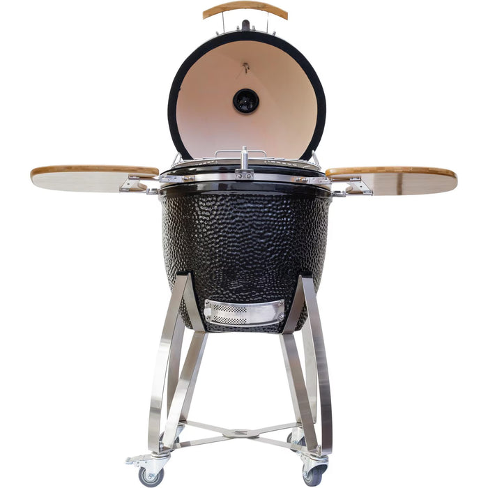 Stono Outdoor Living The Coyote Asado Smoker w/ Stand & Side Shelves (C1CHCS-FS) is a black ceramic kamado-style charcoal grill with a domed lid, wooden side shelves, vented lower front, and wheeled metal stand—ideal for outdoor cooking.