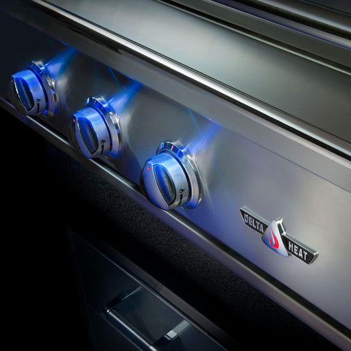Stono Outdoor Living Close-up of three stainless steel knobs with blue LED lights on the Delta Heat 32-Inch 3-Burner Built-In Propane Gas Grill (DHBQ32RS-DL), showcasing its premium design and infrared Sear Zone. The Delta Heat logo is seen on the lower right panel.