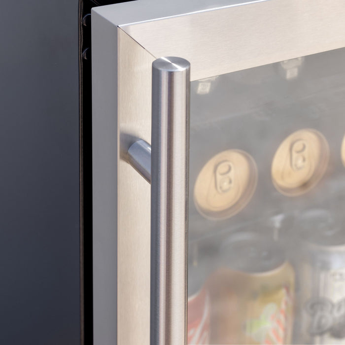 Stono Outdoor Living Close-up of the stainless steel handle on the TrueFlame 24" 5.1 Cu. Ft. Outdoor Rated Refrigerator (AMD-RFR-24G) by TrueFlame, with several cans of beverages visible inside through the glass door.