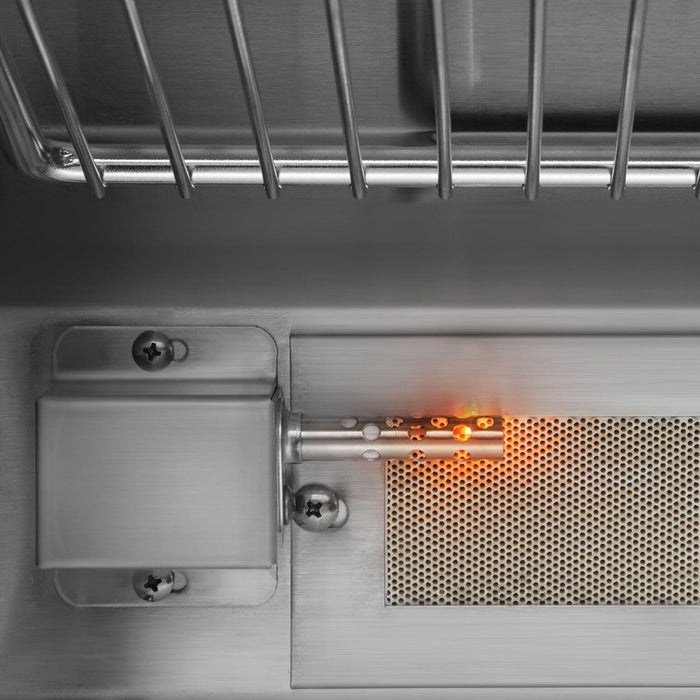 Stono Outdoor Living Close-up of the Twin Eagles 54-Inch 4-Burner Built-In Natural Gas Grill with Sear Zone & Two Infrared Rotisserie Burners (TEBQ54RS-CN), showing stainless steel burners, a glowing igniter, and a perforated plate beneath the grates.