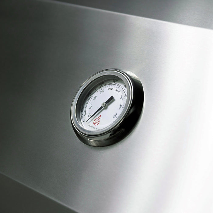 Stono Outdoor Living A close-up of a round metal temperature gauge on the TrueFlame 32" 4-Burner Built-In Propane Gas Grill (TF32L), displaying temperature readings in both Fahrenheit and Celsius.