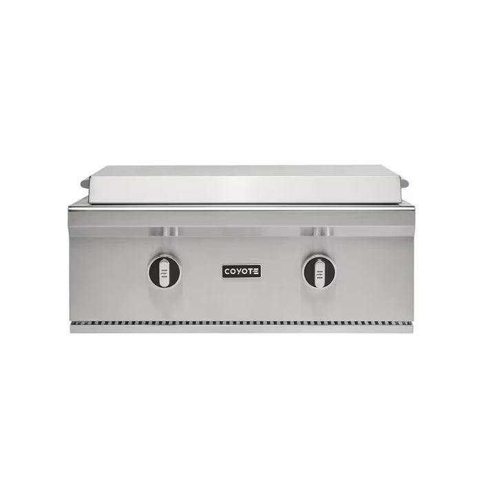 Stono Outdoor Living The Coyote 30" Flat Top Grill in Natural Gas (C3FTG30NG) features a modern, compact stainless steel design with two control knobs and a closed lid—perfect for built-in outdoor kitchens. The Coyote logo is displayed on the front.