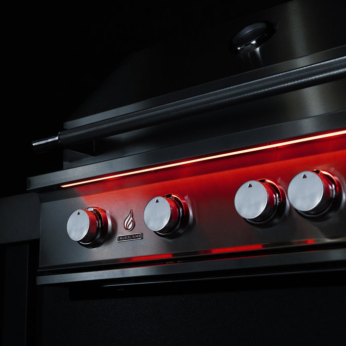 Stono Outdoor Living Close-up of the TrueFlame 40" 5-Burner Built-In Propane Gas Grill (TF40L) by TrueFlame, showcasing its sleek stainless steel design, five round control knobs with red LED lights, flame icon, and minimalist style against a black background.