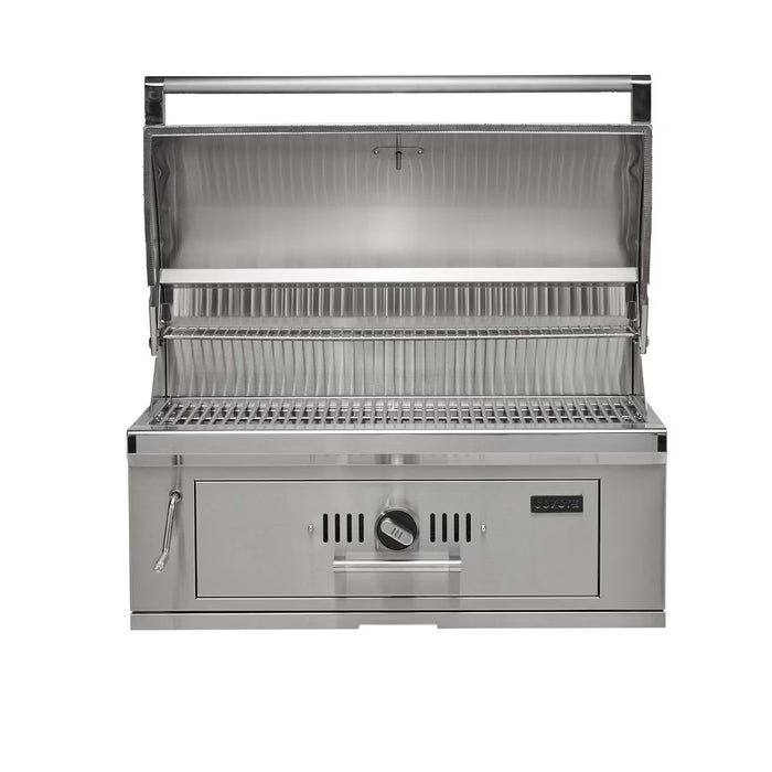Stono Outdoor Living The Coyote 36" Charcoal Grill, Built-in - C3CH36 is a stainless steel grill with dual cooking grates, a hood, and front control knob. This outdoor-ready Coyote grill is clean and perfect for cooking.