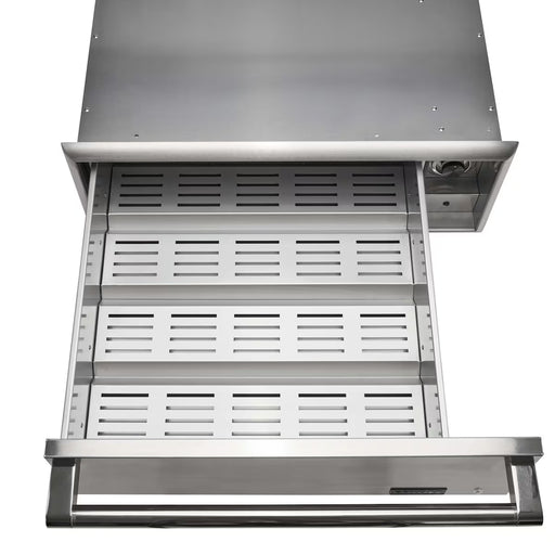 Stono Outdoor Living The Coyote Warming Drawer - C3-WD by Coyote is shown partially open from above. This stainless steel warming drawer features a vented, perforated tray, solid handle, and a control knob on the upper right—ideal for outdoor kitchens.