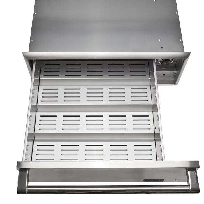 Stono Outdoor Living The Coyote Warming Drawer - C3-WD by Coyote is shown partially open from above. This stainless steel warming drawer features a vented, perforated tray, solid handle, and a control knob on the upper right—ideal for outdoor kitchens.