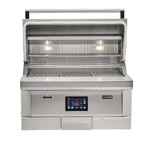 Stono Outdoor Living Front view of the Coyote 36" Pellet Grill - C2P36 with advanced digital controls, two interior lights, a partially open lid, stainless steel front featuring the Coyote brand, and grates for outdoor cooking.