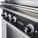 Stono Outdoor Living Close-up of a Wildfire Outdoor Living Ranch Pro 42" Gas Grill (WFPRO42G-BSS-NG) in black stainless steel, shown in an outdoor kitchen with four illuminated control knobs and the brand logo on the front panel.