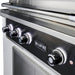 Stono Outdoor Living Close-up of the Wildfire Ranch Pro 30" Gas Grill 304 Black SS Propane by Wildfire Outdoor Living, featuring four illuminated control knobs and the brand logo on the front panel.
