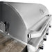 Stono Outdoor Living Close-up of the Wildfire Outdoor Living Ranch Pro 36-in 3 Burner Black 304 SS Natural Gas Grill (WFPRO36G-BSS-NG), featuring stainless steel burners, multiple control knobs, and a closed lid beside a wooden countertop.