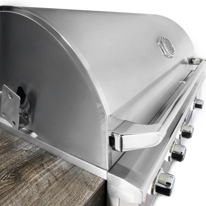 Stono Outdoor Living Close-up of the Wildfire Outdoor Living Ranch Pro 30" Gas Grill 304 Black SS Propane (WFPRO30G-BSS-LP) with closed lid, temperature gauge, and control knobs visible beside a wooden surface in an outdoor kitchen.
