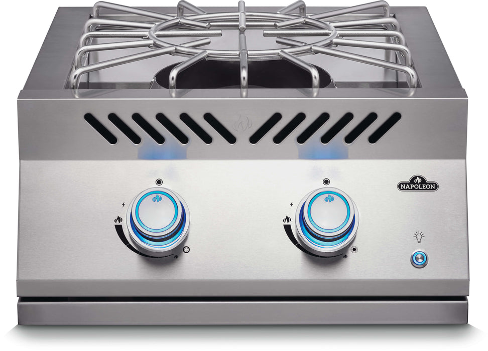Stono Outdoor Living The Napoleon Built-In 700 Series Propane Gas Power Burner (BIB18PBPSS) features a stainless steel cover, two control knobs with blue indicator lights, and a metal grate. The Napoleon brand appears on the front panel.