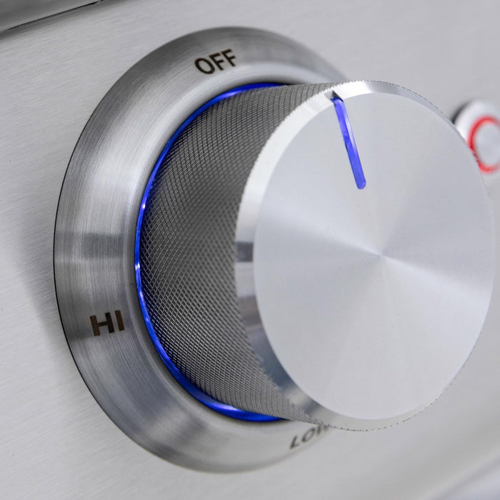 Stono Outdoor Living A close-up shows a Blaze Premium LTE+ 32" grill's stainless steel control knob, set between OFF and HI, with a blue indicator light glowing around the dial.