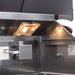 Stono Outdoor Living Close-up of the Blaze Premium LTE+ 32" 4-Burner Propane Grill’s stainless steel interior with built-in grill lights illuminating searing rods and metal components, all backed by Blaze’s lifetime warranty. Model: BLZ-4LTE3-LP.
