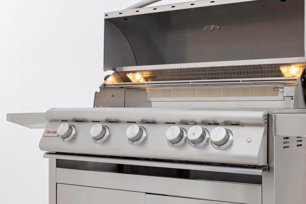 Stono Outdoor Living A Blaze Premium LTE+ 40" 5-Burner Propane Grill with rear infrared burner and grill lights, featuring stainless steel burners and interior lights under an open lid, is shown on a white background. Enjoy a lifetime warranty from Blaze.