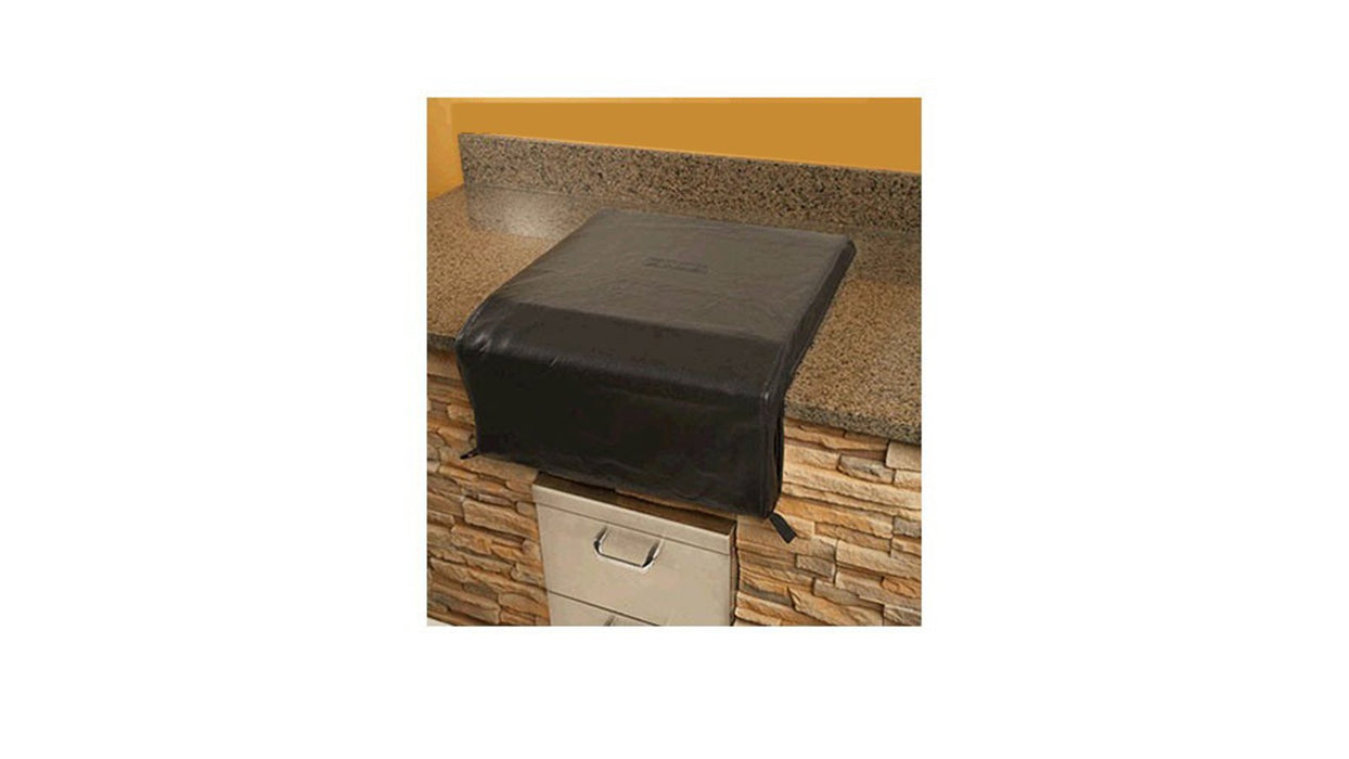 Stono Outdoor Living The Lynx Power Burner Carbon Fiber Vinyl Cover (CCLPB) by Lynx protects a granite countertop with a stone-front cabinet beneath, set against a yellow wall.