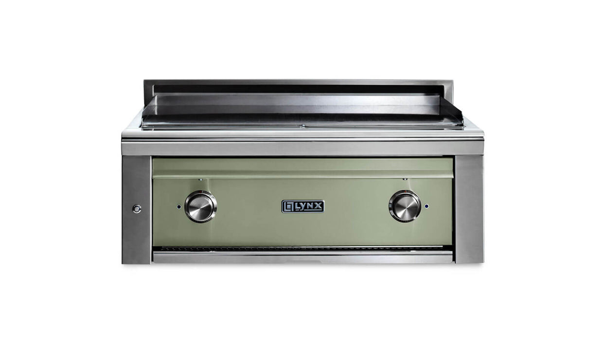 Stono Outdoor Living The Lynx 30” Asado Built-In Grill in Desert Sage (L30AG-DSNG) features stainless steel, a green front panel with two control knobs, and the Lynx logo—an ideal luxury grill for outdoor kitchens, showcased against a white background.