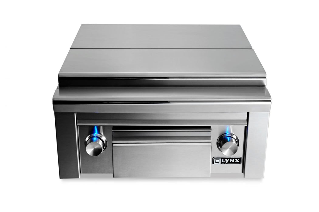 Stono Outdoor Living The Lynx Double Side-by-Side Burners (LSB2PC-1-NG) features stainless steel construction, two brass burners, a maple cutting board, a storage drawer, and blue-lit control knobs—ideal for any outdoor kitchen.