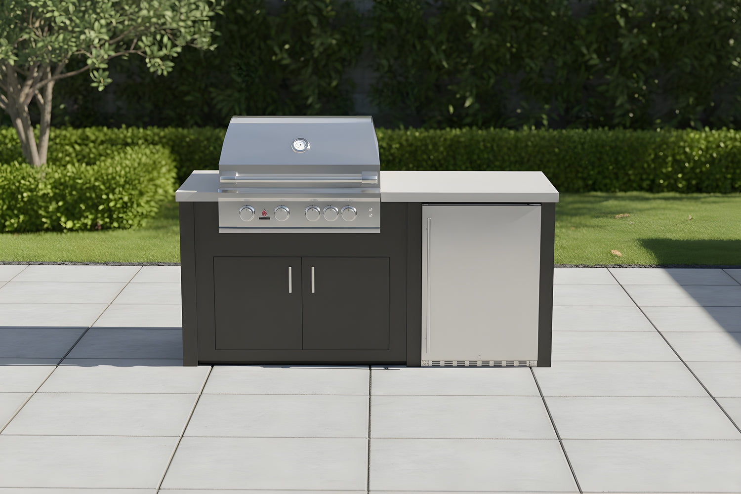 Stono Outdoor Living A modern outdoor grill station with a stainless steel grill and closed storage cabinets stands on a patio with gray tiles, surrounded by green bushes and trees.