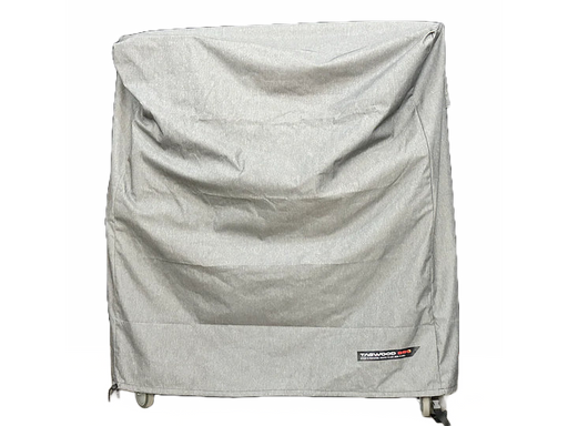 Stono Outdoor Living A large wheeled appliance is covered by the Tagwood BBQ BBQ03SS/SI Cover - COVE03, a grey, UV-resistant cover from Tagwood BBQ with visible wrinkles and a small label at the bottom right, set against a plain white background.