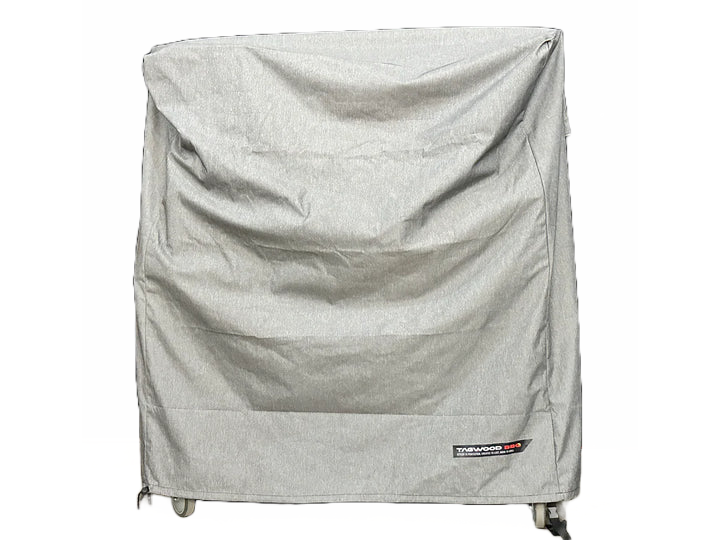 Stono Outdoor Living A large wheeled appliance is covered by the Tagwood BBQ BBQ03SS/SI Cover - COVE03, a grey, UV-resistant cover from Tagwood BBQ with visible wrinkles and a small label at the bottom right, set against a plain white background.